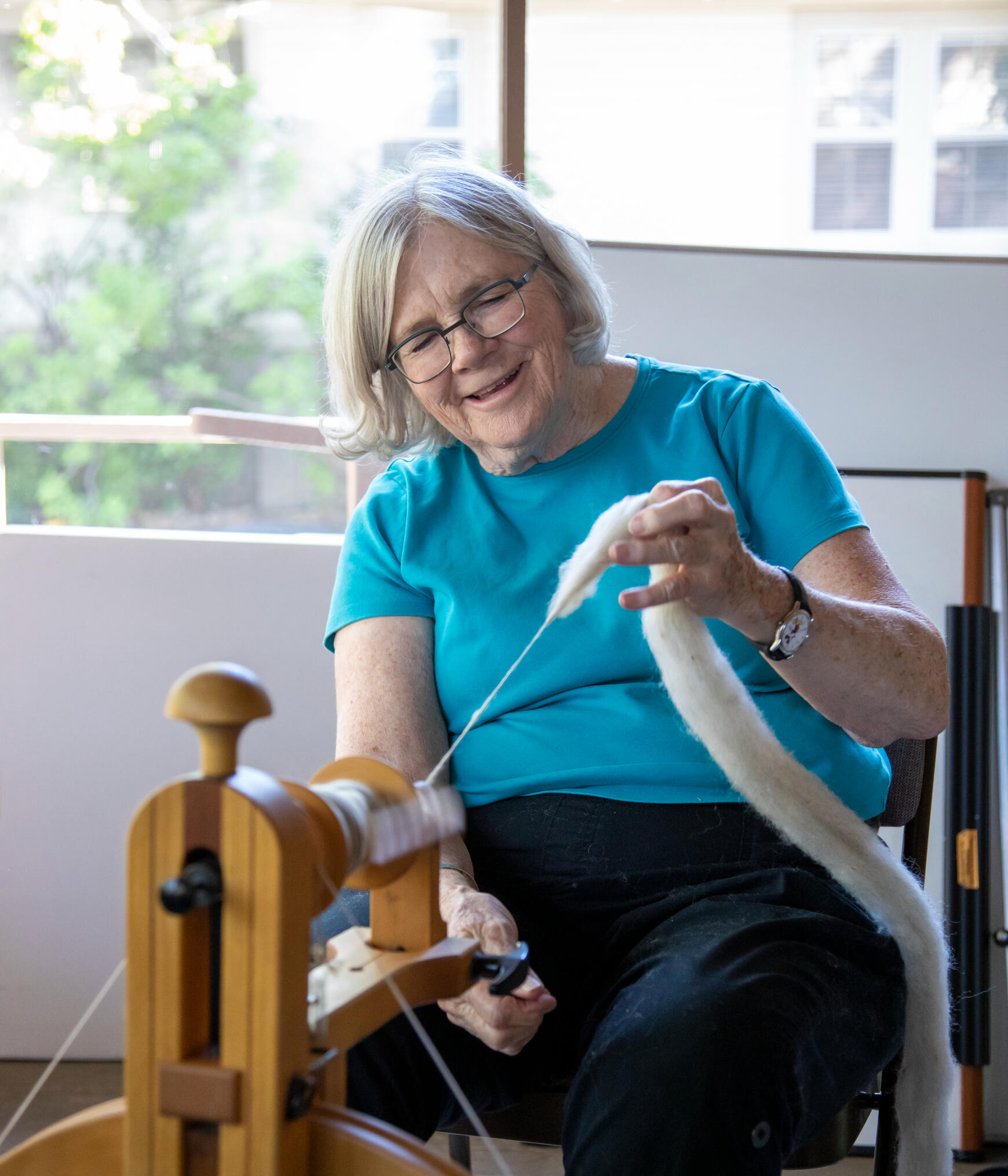 Maggie Casey spinning at the wheel in one of her past classes.